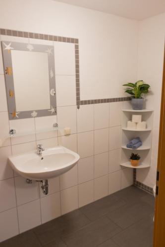 a bathroom with a sink and a mirror at Ferienanlage Inselzauber in Gustow