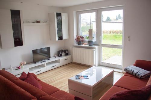 a living room with a couch and a tv at Ferienanlage Inselzauber in Gustow