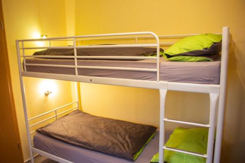two bunk beds in a room with yellow walls at Ferienanlage Inselzauber in Gustow