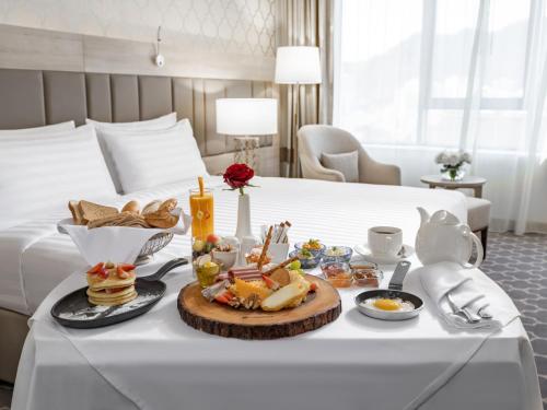 a tray of food on a table in a hotel room at Wirgan Hotel Al Azizyah in Makkah