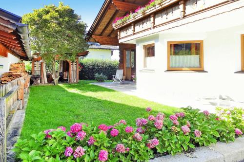 a yard of a house with pink flowers at holiday home, Axams in Innsbruck
