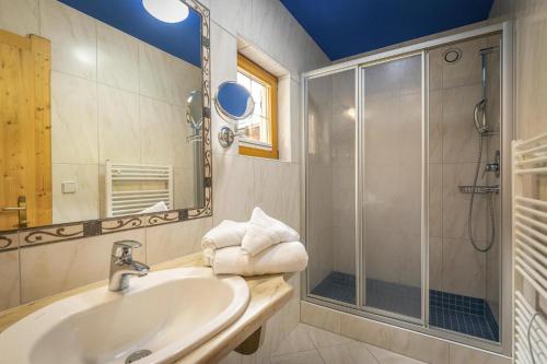 a bathroom with a sink and a shower at Chalet in Fügen near Spieljochbahn Lift in Fügen