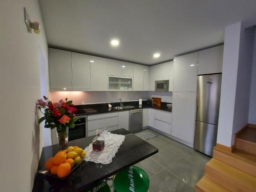 a kitchen with a table with fruit on it at Soalheira Douro House in Vale de Mendiz