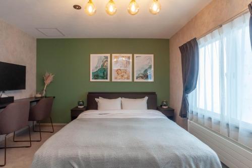 a bedroom with a large bed and a window at Rusutsu Grand Cabin - Vacation STAY 16626v in Kimobetsu