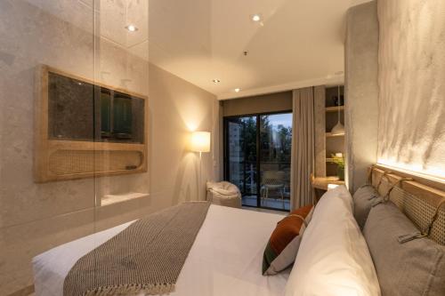 a bedroom with a bed and a large window at Landmark Hotel in Medellín