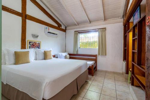 Cama ou camas em um quarto em Pousada Tambayba