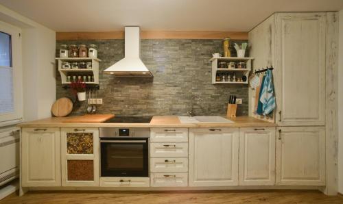 a kitchen with white cabinets and a stove at Sea house in Izola