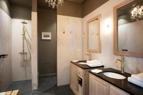 a bathroom with a sink and a shower at Mansion9Bruges in Bruges