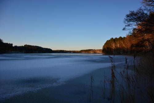 a large body of water with snow on it at Sowa i Kumple in Drezdenko
