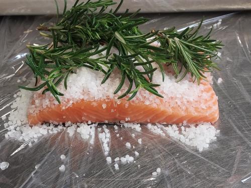 a piece of salmon with rice and greens on top at Rezydencja Izabella in Wisła