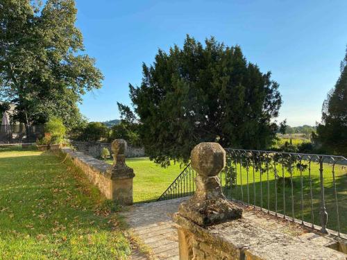 a fence with stone statues next to a field at Château MontPlaisir charming b&b in Provence in Valréas