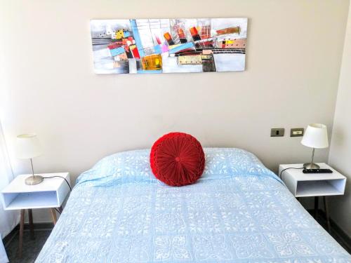 a red pillow sitting on a bed in a bedroom at 2 Torres Calama in Calama