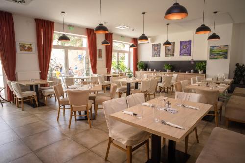 a restaurant with tables and chairs in a room at BIVIO hotel in Bratislava