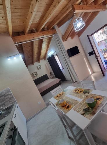 a kitchen and living room with a table and chairs at Martina's Place (with panoramic views) in Chia
