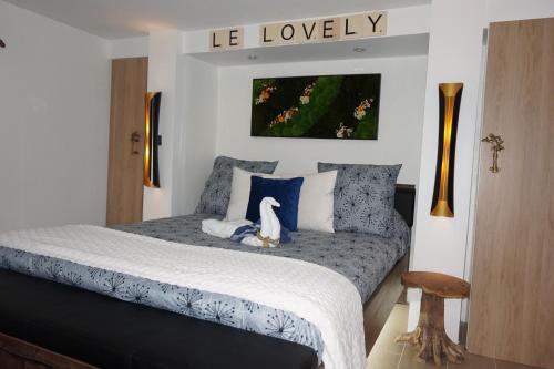 a bedroom with a bed with a dog sitting on it at Lovely Nature in Berck-sur-Mer