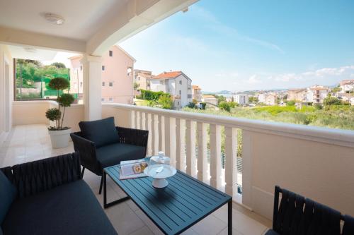 a balcony with chairs and a table with a view at Elais Luxury Residence in Podstrana