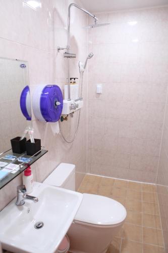 a bathroom with a shower and a toilet and a sink at Ellen House in Seoul