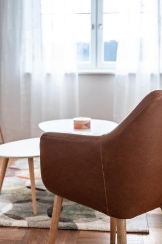 a living room with a chair and a table at OMA's Apartment in Haus GRETE in Bad Waltersdorf
