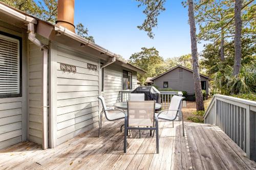 a patio with a table and chairs on a deck at Oceanwoods 452 in Kiawah Island