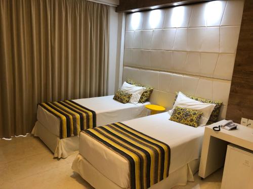 מיטה או מיטות בחדר ב-Hotel Giordano Mantiqueira