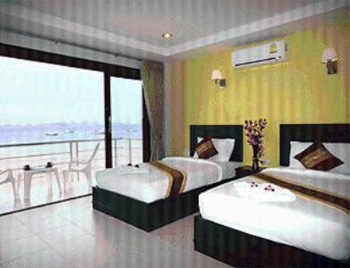 a hotel room with two beds and a balcony at Koh Kwang Seaview in Klong Muang Beach