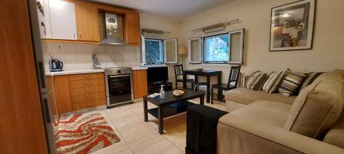 a living room with a couch and a table at The Seasons of Nickolas in Ayia Evfimia