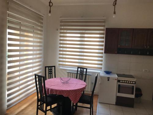 a kitchen with a table with a pink table cloth at STIV, Voždovac, Stepa Stepanovic in Voždovac