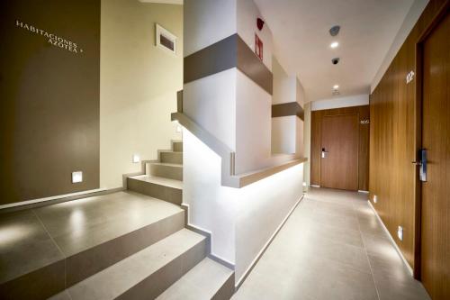 a hallway with stairs in a building at Hostal Pericón in Conil de la Frontera