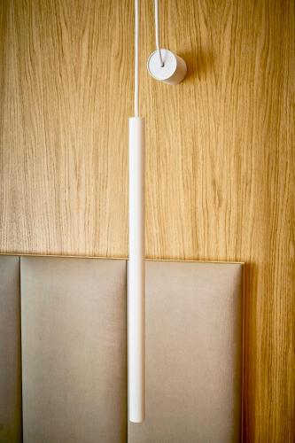 two white lights hanging from a wooden wall at Hostal Pericón in Conil de la Frontera