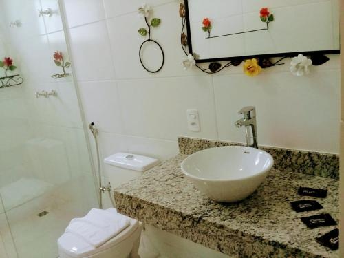 a bathroom with a sink and a toilet at Hotel Pousada Riacho da Areia in Águas de Lindóia