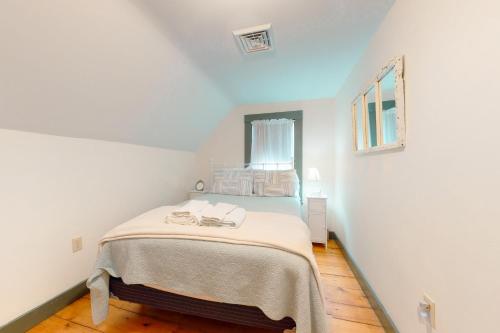 a bedroom with a bed in a white room at Salty Ridge Station in Orleans