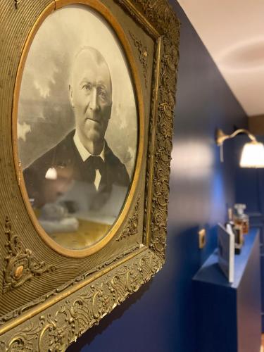 a framed picture of a man in a suit at LA TOUR YVELINE in Romans-sur-Isère
