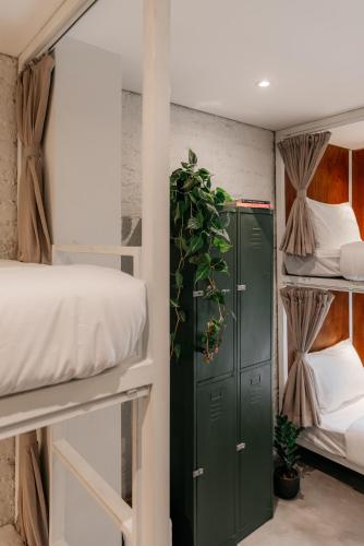 a room with bunk beds and a green locker at Tamni in Bangkok