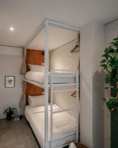 a couple of bunk beds in a room at Tamni in Bangkok