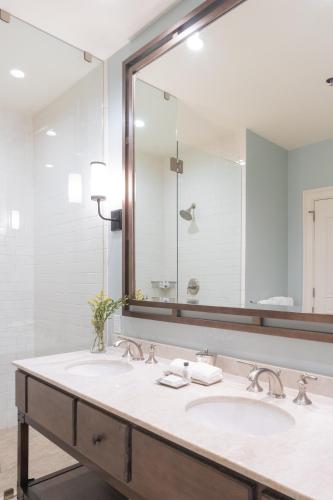 a bathroom with a sink and a large mirror at NOPSI Hotel New Orleans in New Orleans
