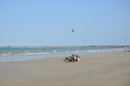 a person riding a motorcycle on the beach at Bleu Outremer in Saint-Cast-le-Guildo