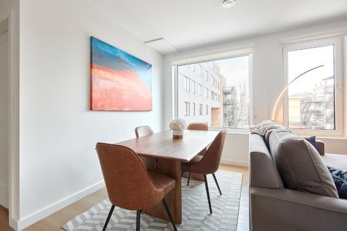 a living room with a table and a couch at Harmony Lofts on Jackson 2 in Hoboken