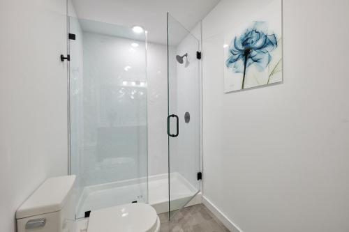 a bathroom with a toilet and a glass shower at Harmony Lofts on Jackson 2 in Hoboken