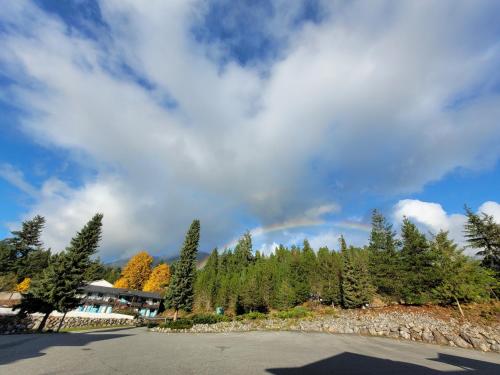 a rainbow in the sky over a parking lot at Ridgeview Motor Inn in Gold River