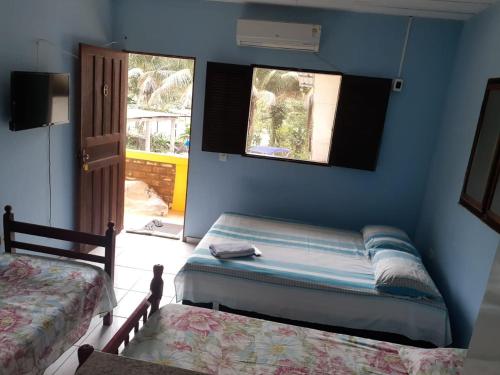 Una cama o camas en una habitación de Pousada Milton