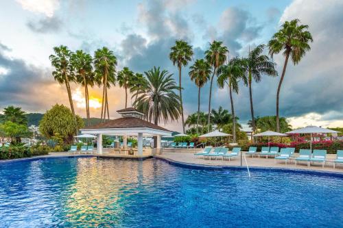 a pool at a resort with chairs and palm trees at Moon Palace Jamaica in Ocho Rios