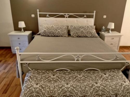 a bedroom with a large bed with two night stands at Casa Bella in Siracusa