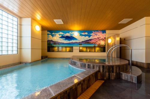 a large swimming pool in a building at The Happo by HHG in Hakuba