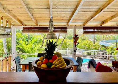a bowl of fruit on a table in a house at Habitation gens bois in Le Diamant