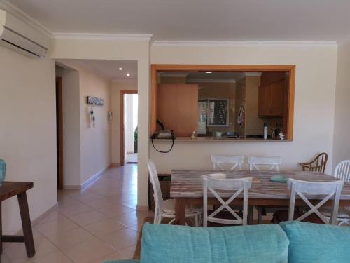 a dining room and kitchen with a table and chairs at Alvor Vila da Praia in Alvor