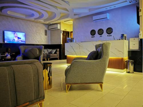 a living room filled with furniture and a tv at TAJ Hotel in Aqaba