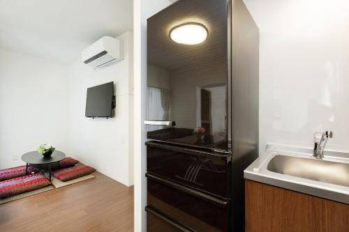 een kleine badkamer met een wastafel en een wastafelmeubel bij Ideal Fukushima in Osaka