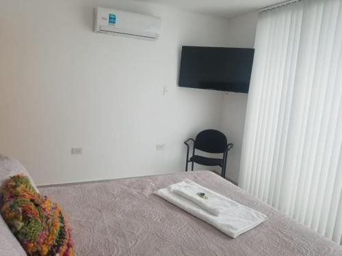 a hotel room with a bed with a towel on it at Ayres de Nieva 2 in San Salvador de Jujuy