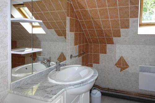 a bathroom with a sink and a tub at Apartment in Bénodet near Sandy Beaches in Bénodet