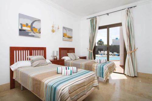 プラヤ・ブランカにあるAlexisのベッドルーム1室(ベッド2台付)、バルコニーが備わります。
